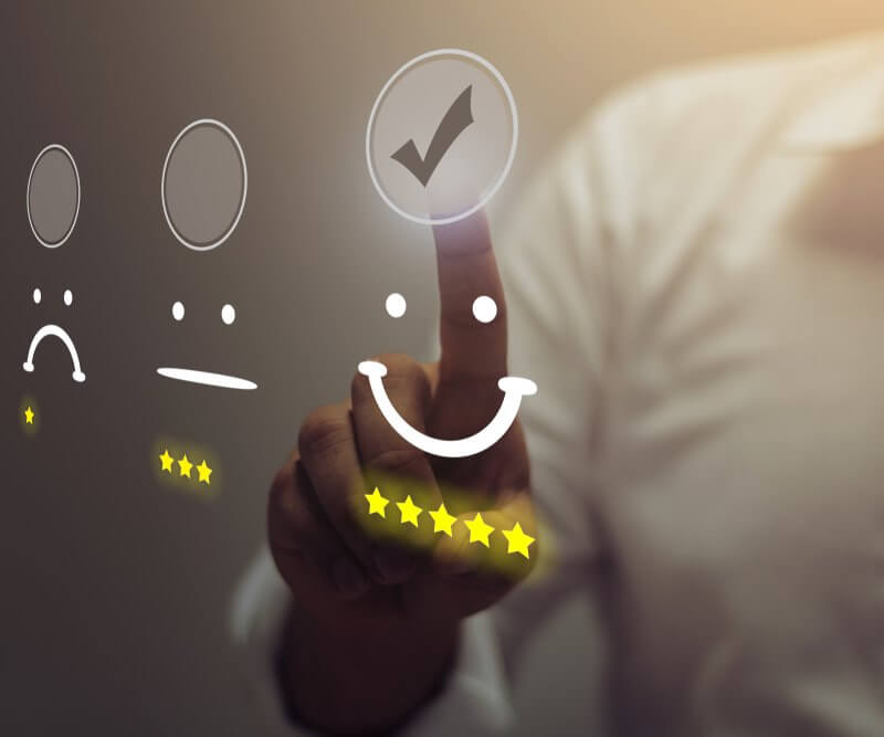 A man pressing a button featuring five stars, symbolizing excellence, associated with Capital Premium Financing.