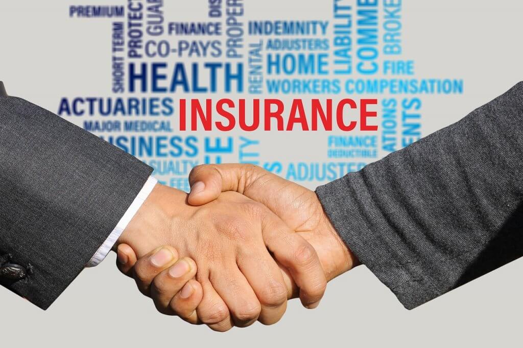 A word cloud featuring "insurance" surrounds two businessmen shaking hands, symbolizing partnership in Capital Premium Financing.