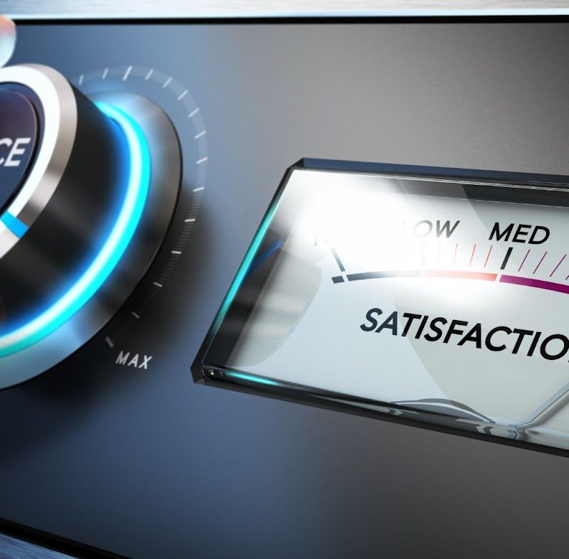 A hand pressing a button on a service level meter, symbolizing customer service in the insurance industry.