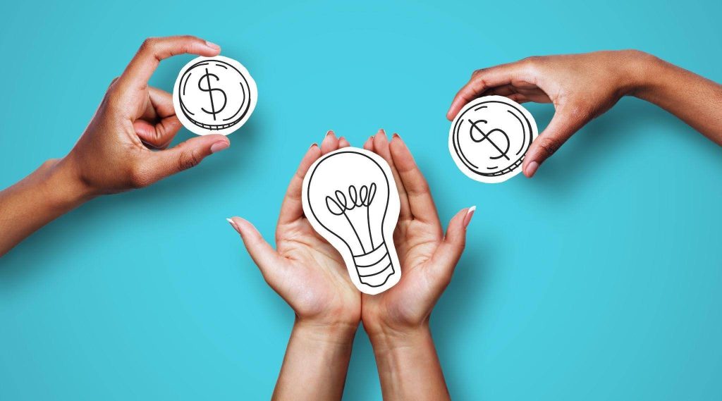 Hands holding dollar signs and a light bulb symbolizing financial ideas and innovation